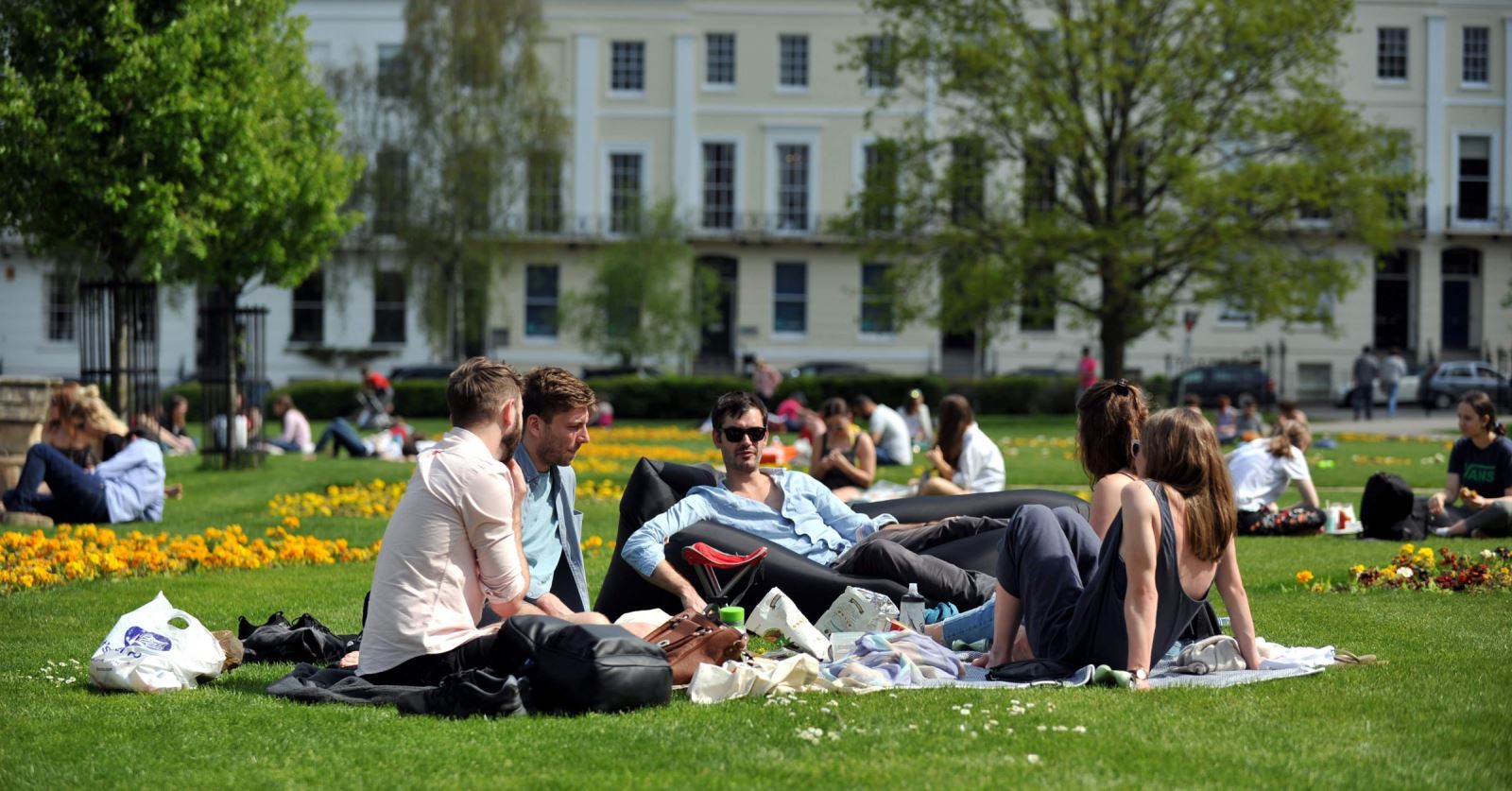 Group enjoying sun in Imperial Gardens, Cheltenham 